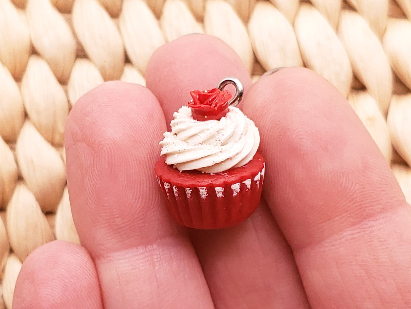 a miniature red velvet cupcake with white frosting